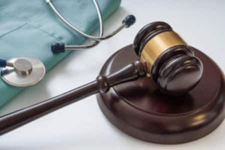 gavel and stethoscope for hospital infection lawyers malpractice case