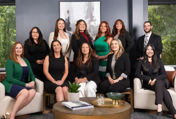 A photo of the Hastings Law Firm medical lawyer's staff positioned around a conference table in one of the offices at the law firm.