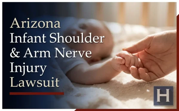 An adult's hand gently holds an infant's tiny hand, underscoring the importance of an Arizona Infant Shoulder & Arm Nerve Injury lawyer.