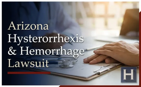 A doctor and another person review documents with a stethoscope nearby, illustrating the serious Hysterorrhexis & Hemorrhage concerns an Arizona lawyer addresses.