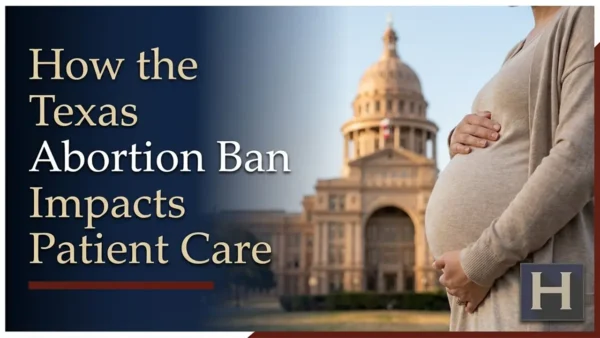 Photo of a pregnant woman holding her stomach in front of the Texas Capitol during an abortion ban protest.