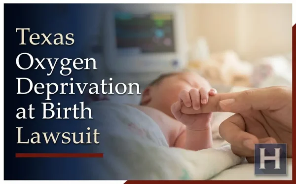 A newborn baby's tiny hand grasps an adult's finger in a hospital, with a medical monitor nearby, reflecting the serious need for a Texas oxygen deprivation at birth lawyer.